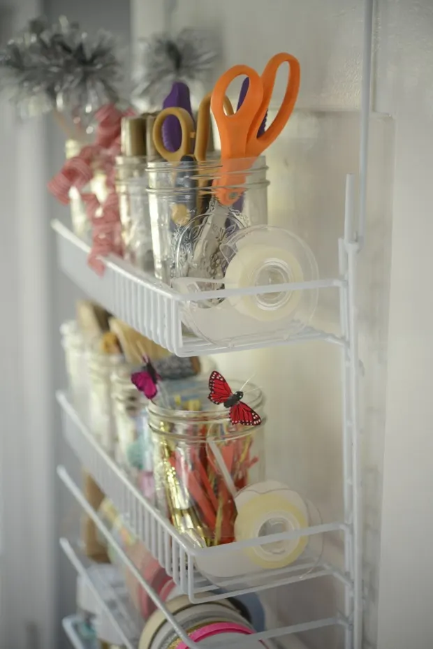 Gift wrapping station ideas for the holidays featuring a wrapping accessories door organization