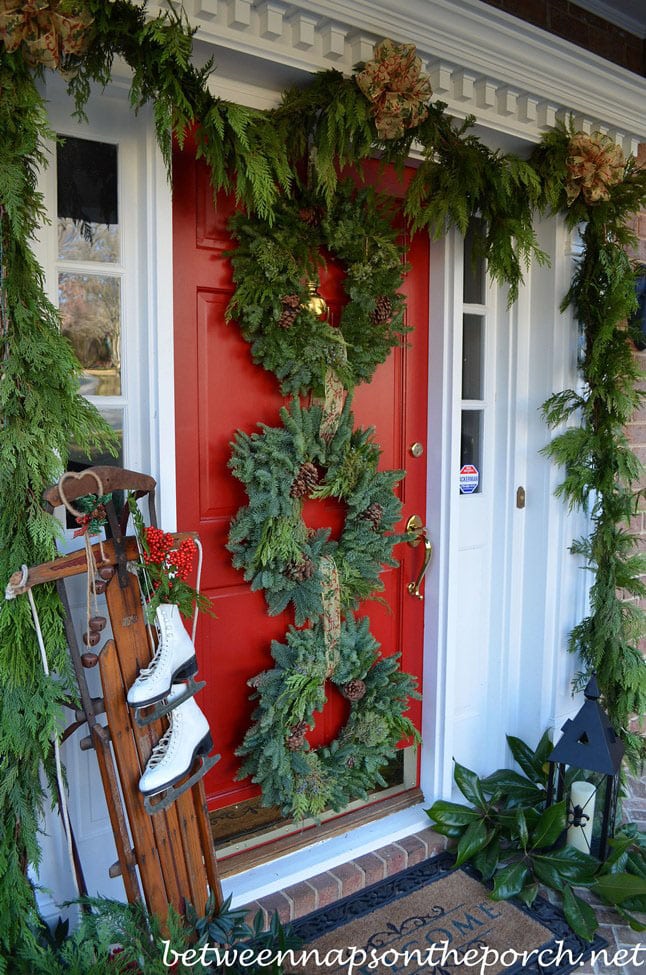 Christmas Wreath idea featuring 3 wreaths stacked on front door in a traditional style