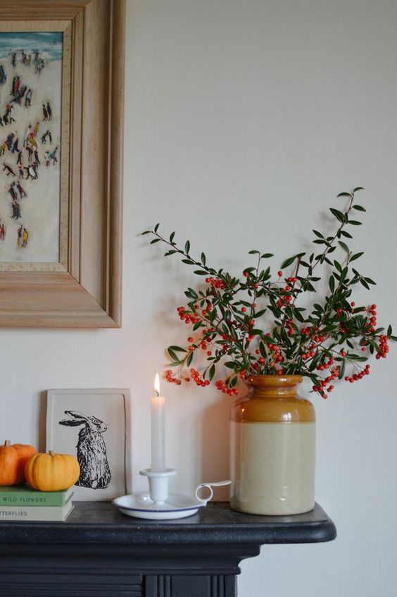 Vignette showcasing transition from Thanksgiving to Christmas decor with a floral arrangement