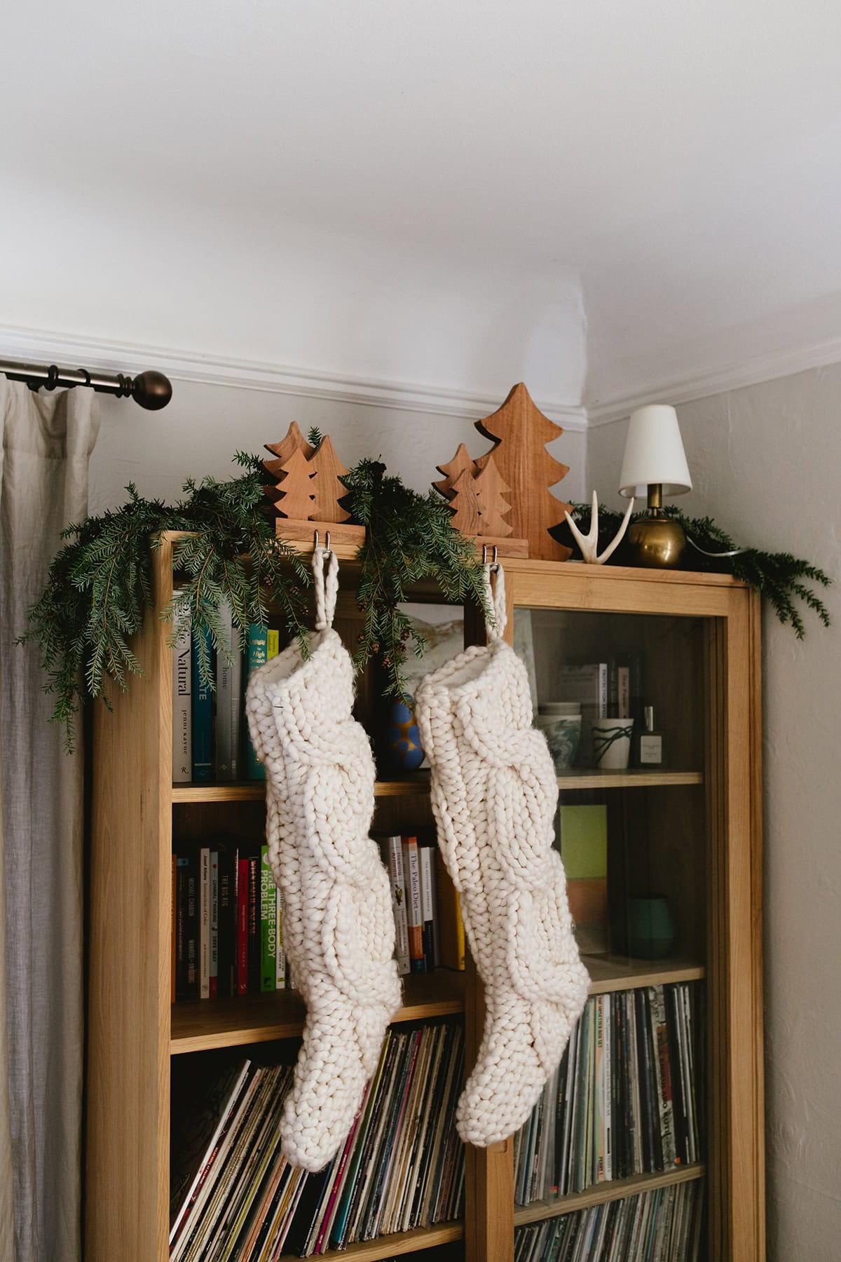 Christmas Stocking Holder Ideas for a Cozy Display Without a Fireplace featuring a stockings hanging from white shelves in modern style