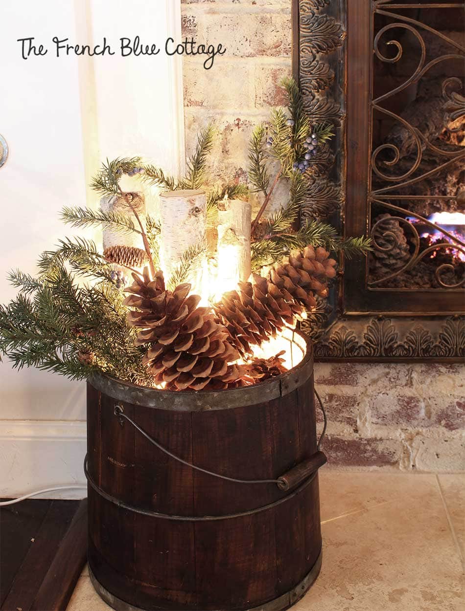 Vignette showcasing transition from Thanksgiving to Christmas decor with a floral arrangement