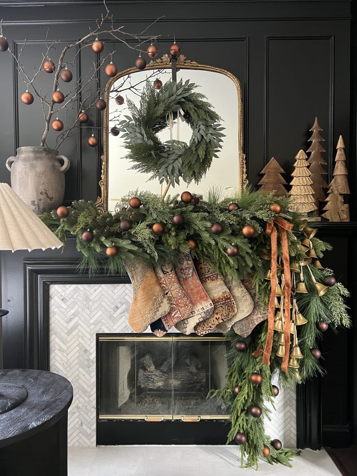 Mantle showcasing transition from Thanksgiving to Christmas decor with large mantle above fireplace