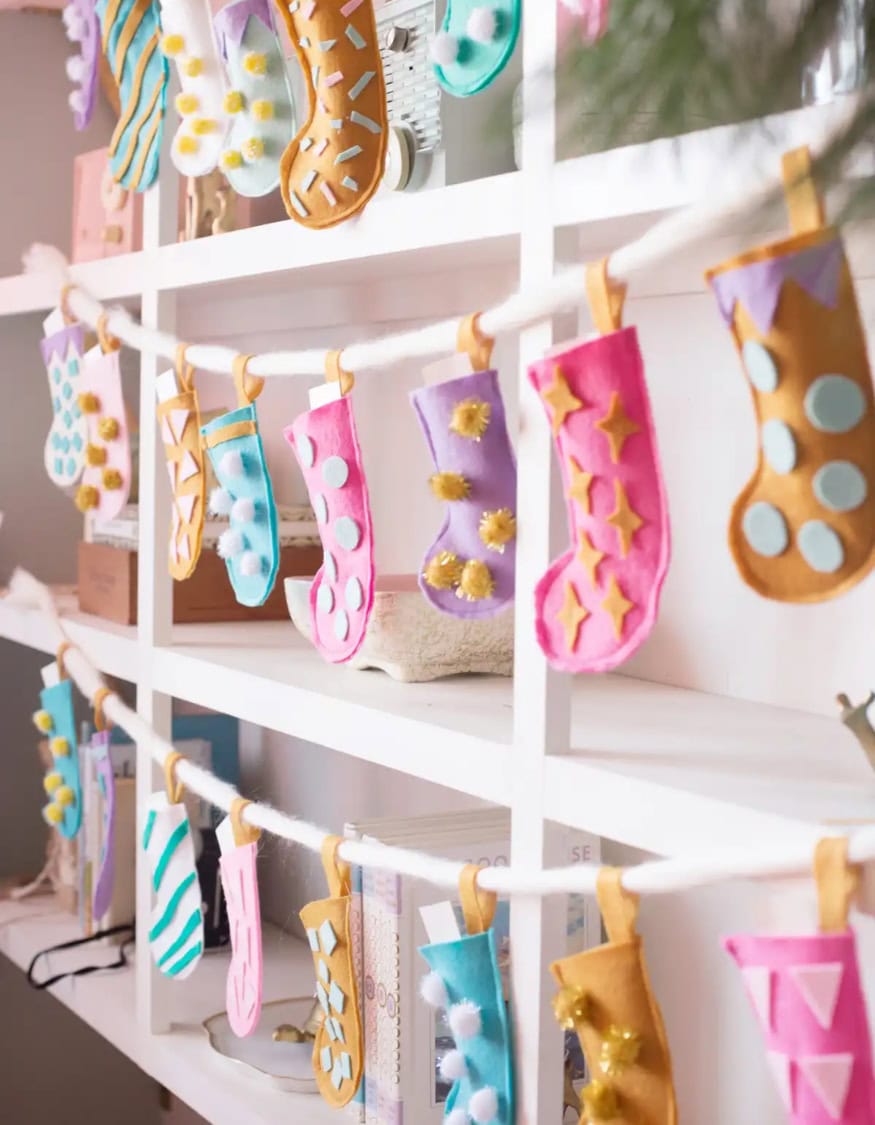 Kid-friendly Christmas decor ideas example featuring a colorful pastel stocking garland DIY