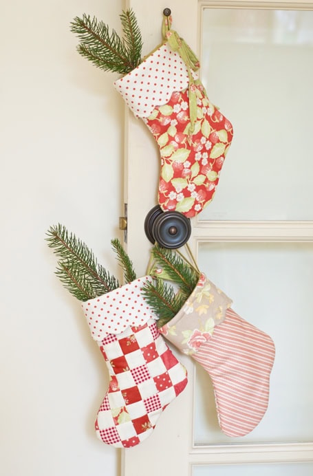 Christmas Stocking Holder Ideas for a Cozy Display Without a Fireplace featuring a stockings hanging from ladder in retro colorful style