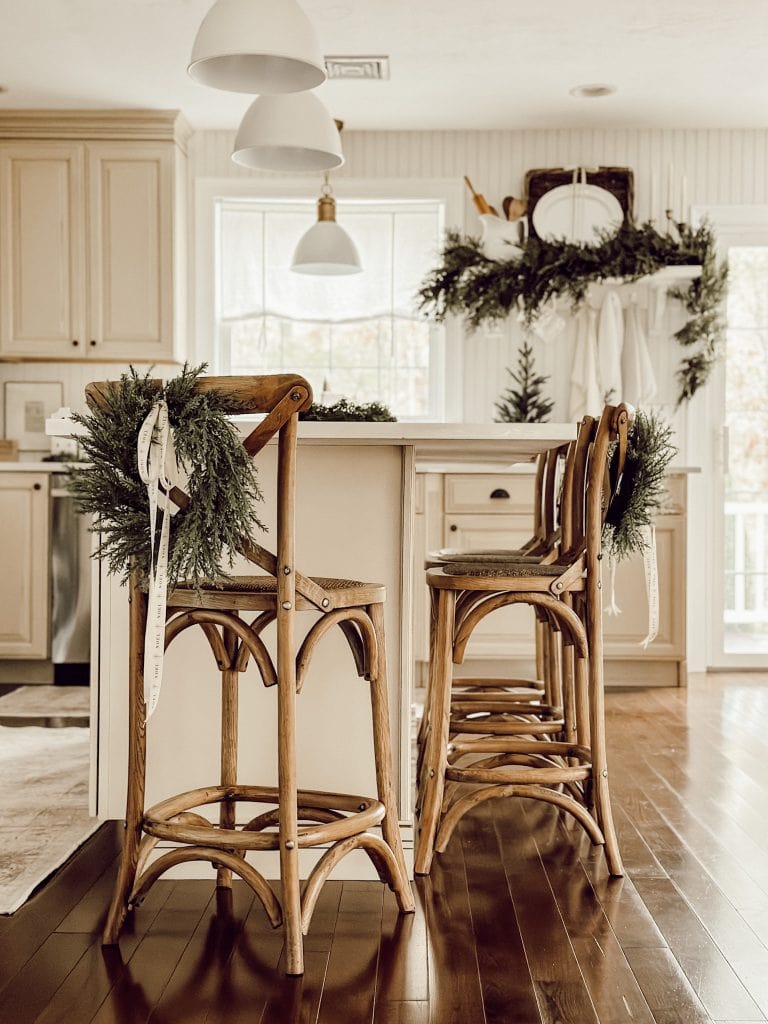 Christmas Wreath idea featuring chair with hung wreath in the back in farmhouse style