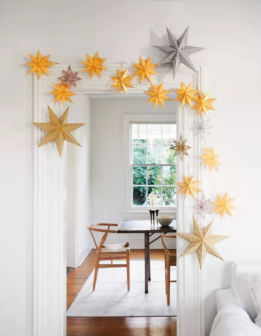 Kid-friendly Christmas decor ideas example featuring paper stars framing a door