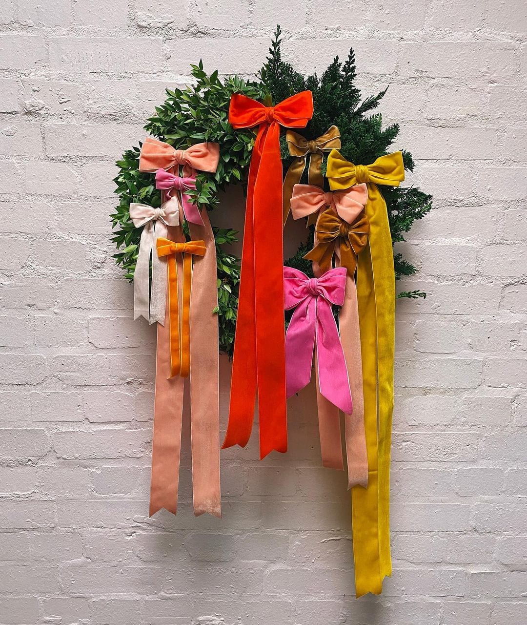 Christmas Wreath idea featuring wreath with colorful velvet bows
