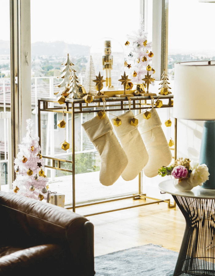 Christmas Stocking Holder Ideas for a Cozy Display Without a Fireplace featuring a stockings hanging from black metallic bar in modern style