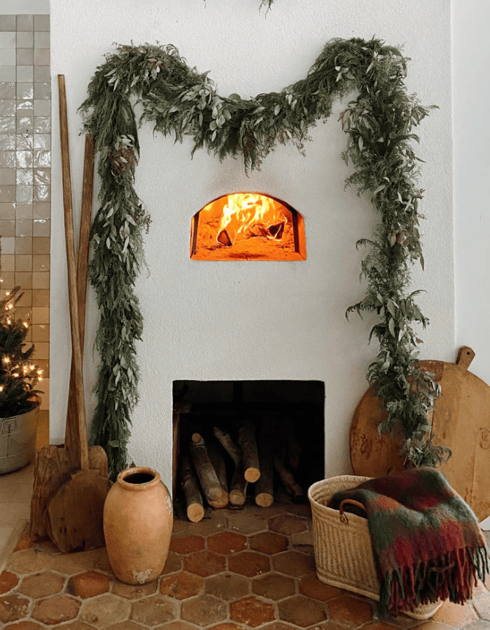 Mantle showcasing transition from Thanksgiving to Christmas decor with large mantle above fireplace