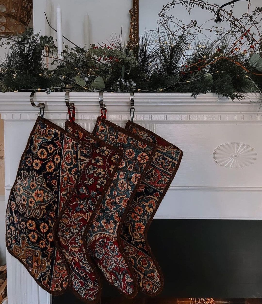 Example of Christmas mantel decor idea featuring a modern traditional look above a fireplace