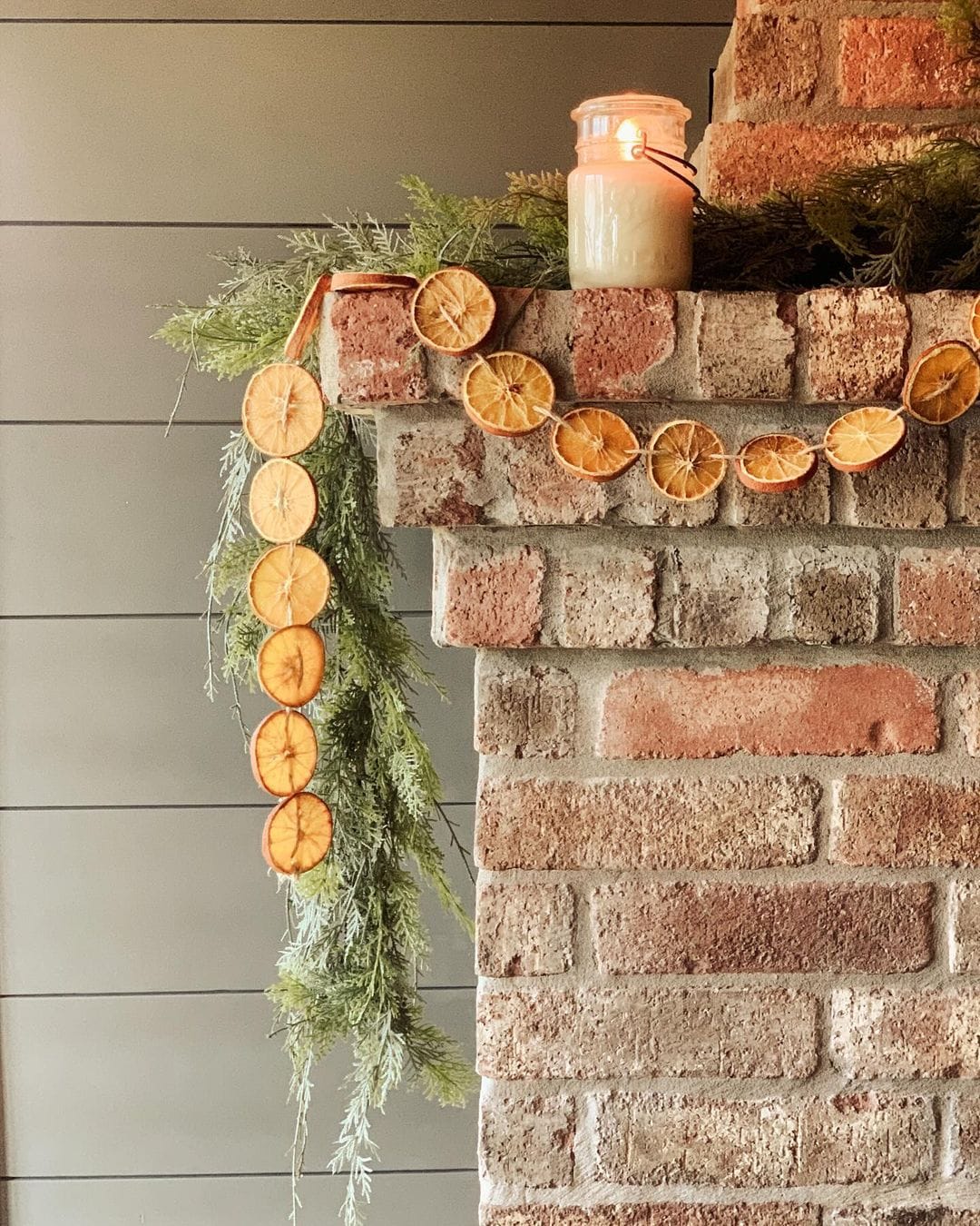 Example of Christmas mantel decor idea featuring a modern rustic look above a fireplace