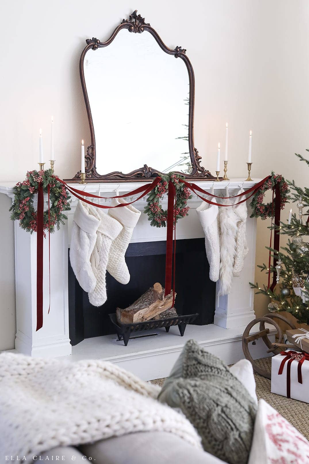 Example of Christmas mantel decor idea featuring a modern traditional look above a fireplace