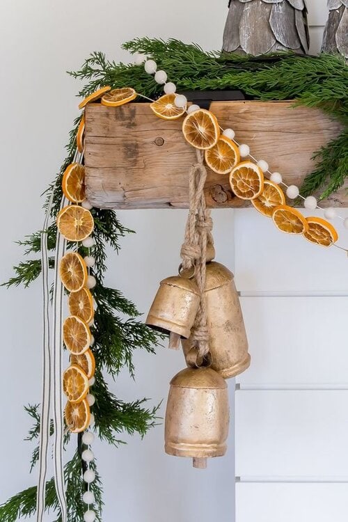 Example of Christmas mantel decor idea featuring a modern rustic look above a fireplace