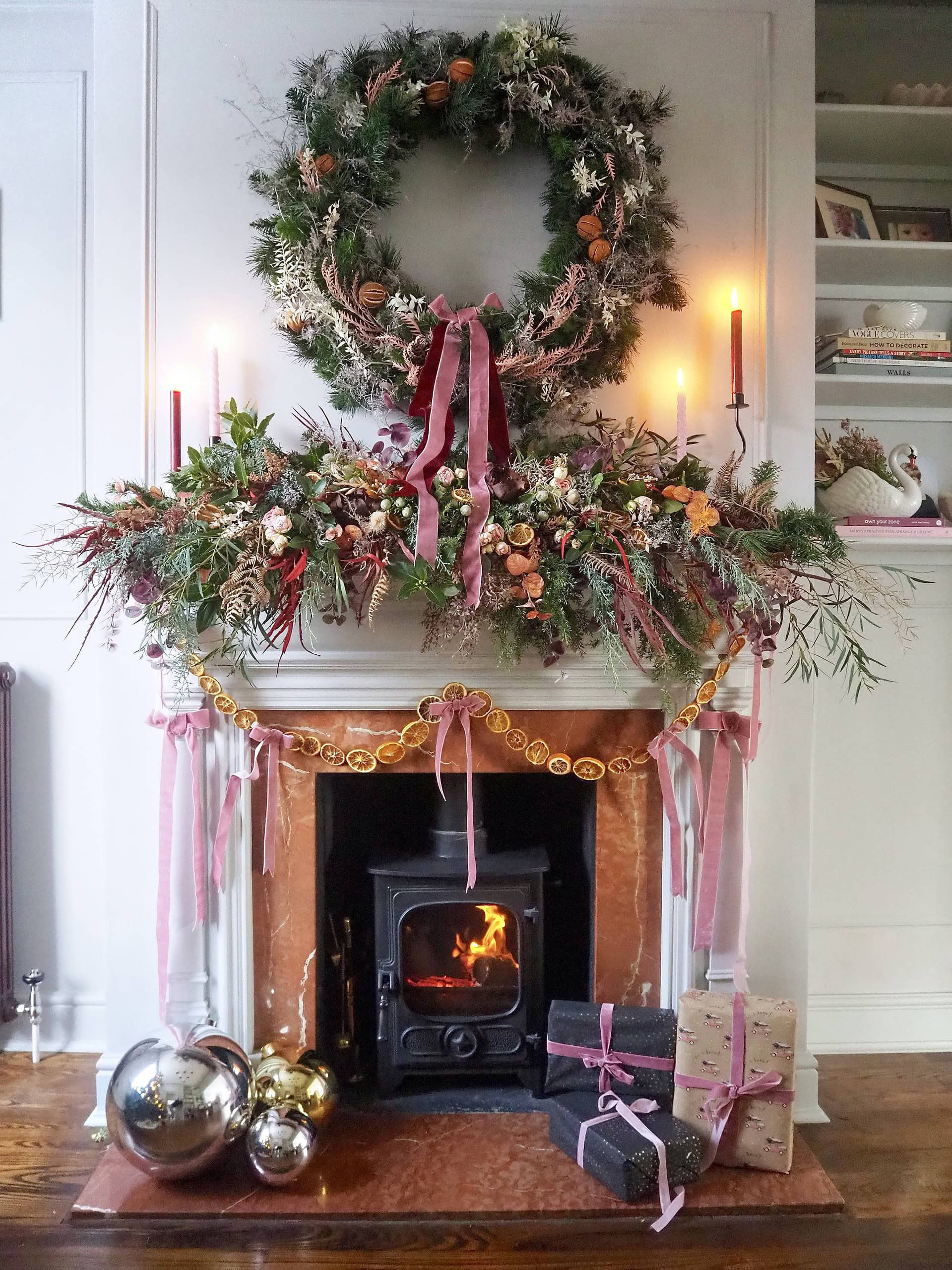 Example of Christmas mantel decor idea featuring a modern romantic look above a fireplace