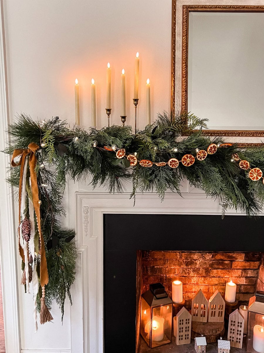 Example of Christmas mantel decor idea featuring a modern rustic look above a fireplace