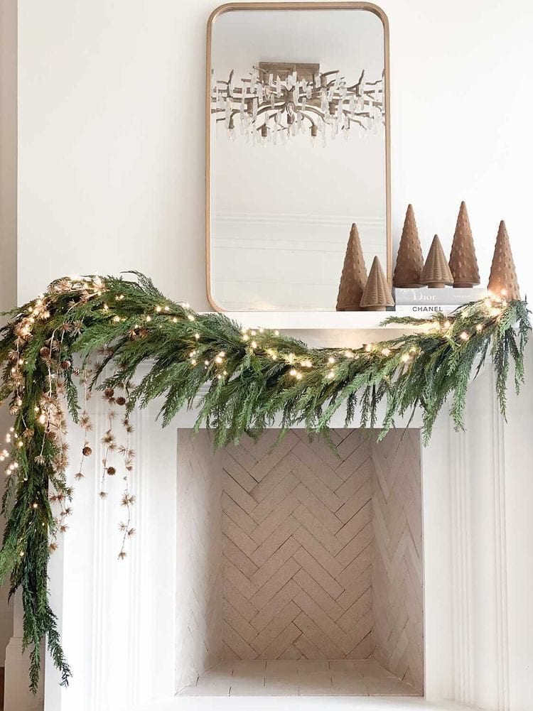 Example of Christmas mantel decor idea featuring a modern traditional look above a fireplace