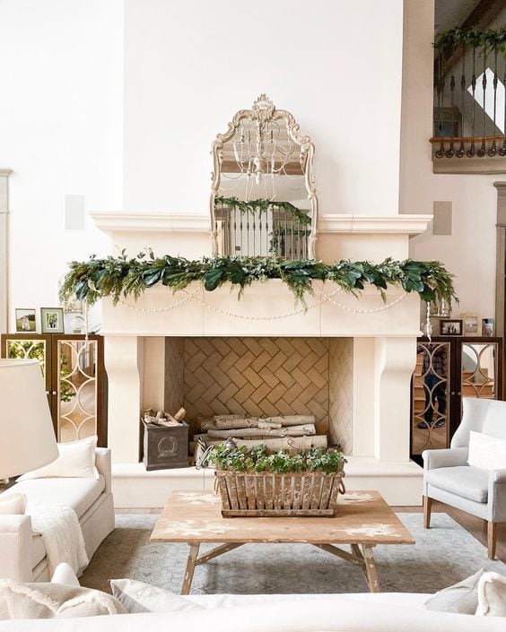 Example of Christmas mantel decor idea featuring a french rustic look above a fireplace