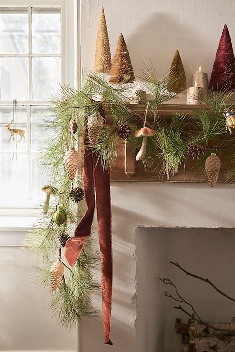 Example of Christmas mantel decor idea featuring a traditional look above a fireplace
