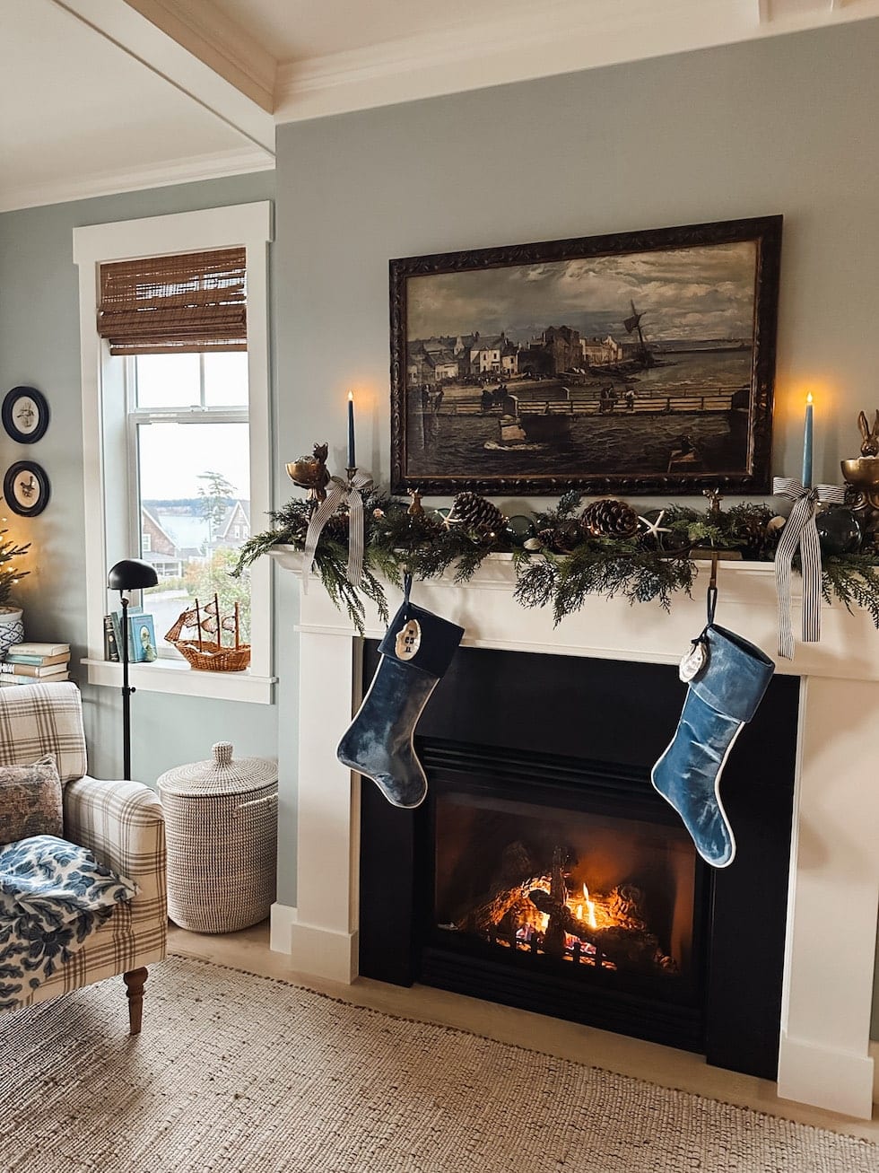 Example of Christmas mantel decor idea featuring a coastal look above a fireplace