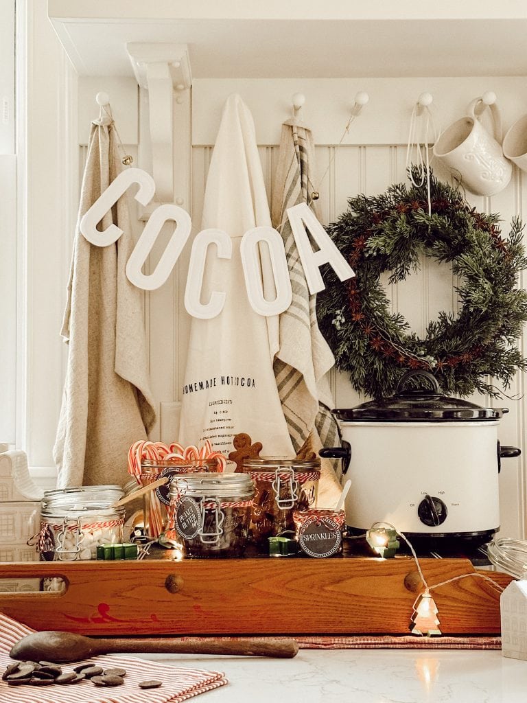 Set up of a hot chocolate bar for holiday party idea in farmhouse style