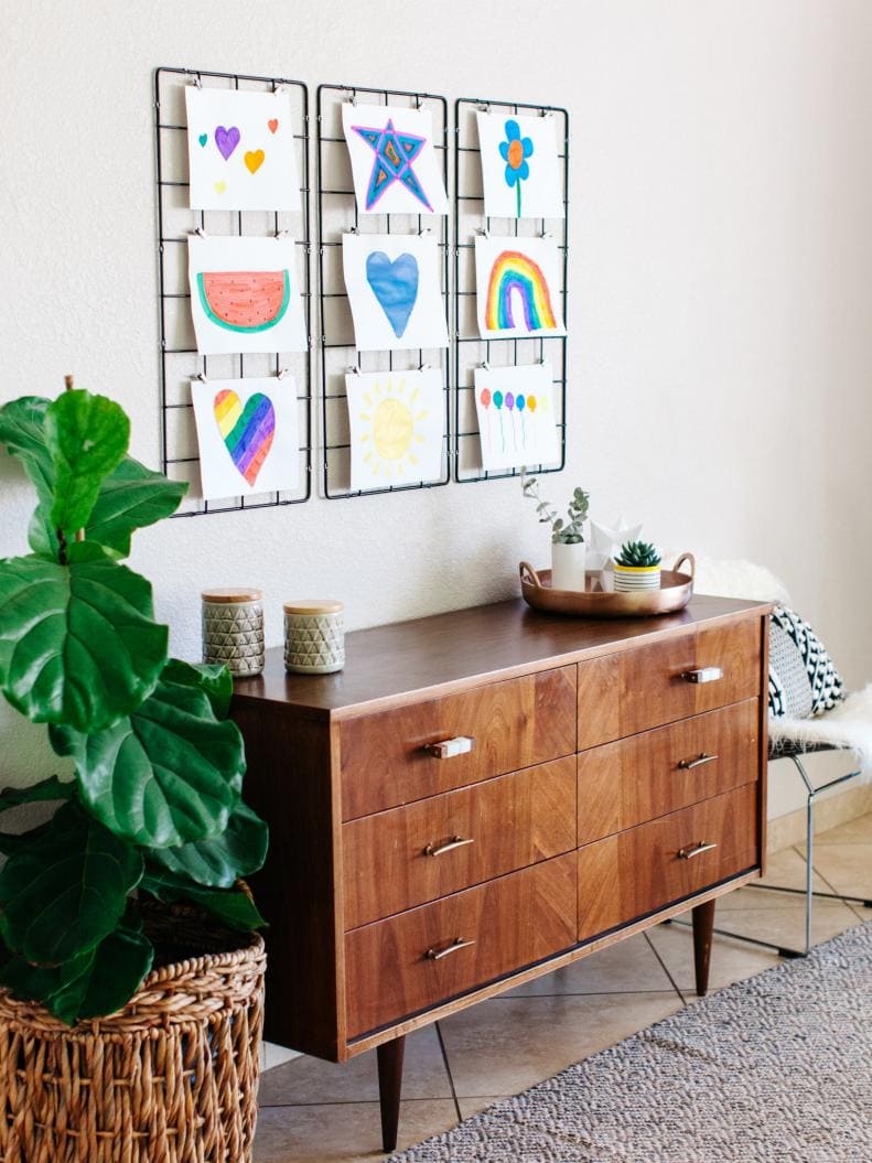 Ideas to display your kids' holiday artwork around the home featuring hanging drawings from a metal grid board