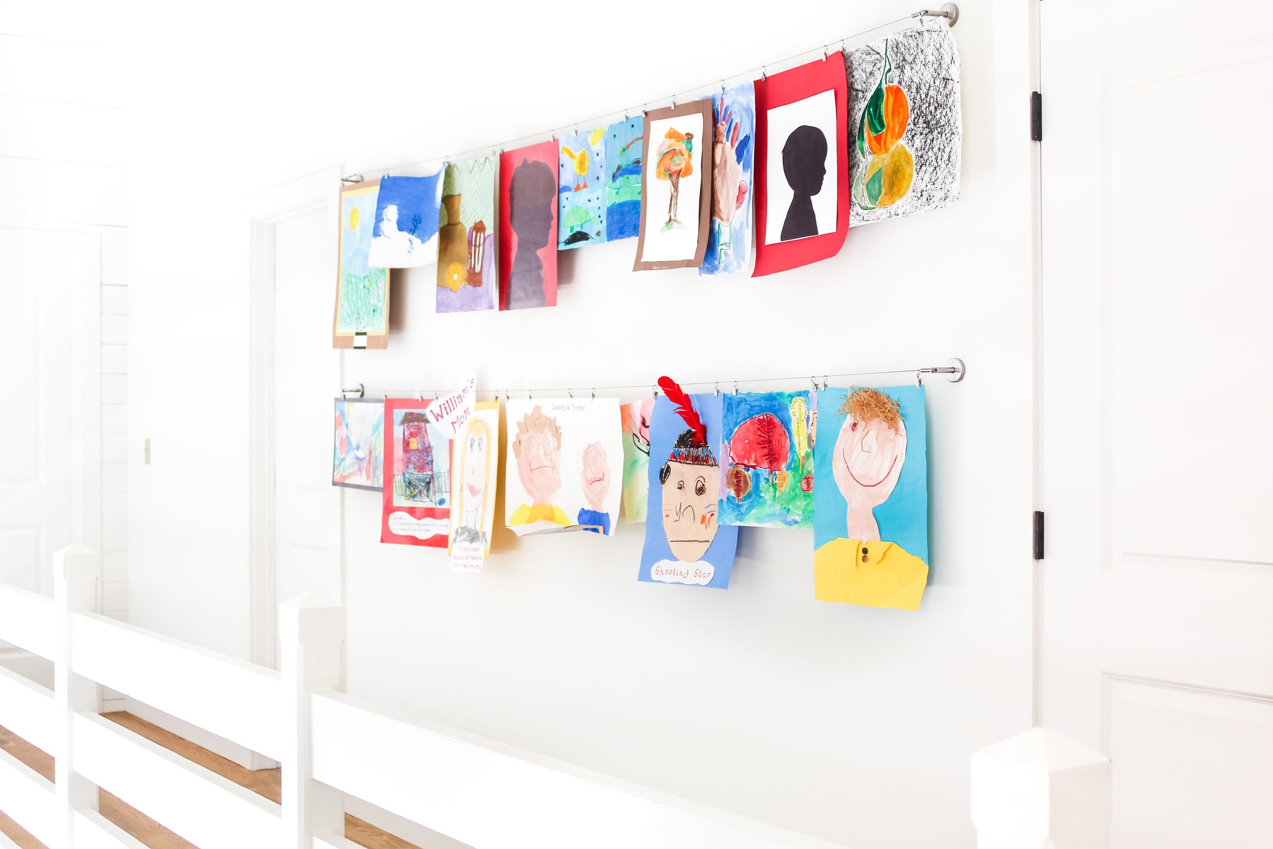 Ideas to display your kids' holiday artwork around the home featuring hanging drawings from string