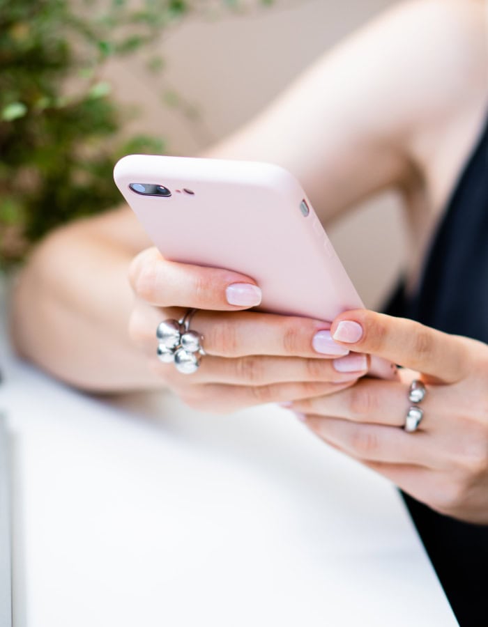 declutter before new years idea featuring womans hands holding a pink cellphone
