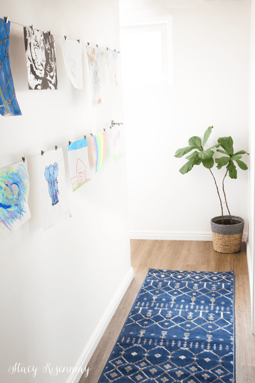 Ideas to display your kids' holiday artwork around the home featuring hanging drawings from string