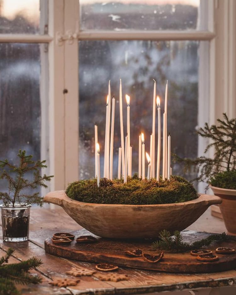 Decorating after Christmas idea featuring a winter decorative element with small white candles in moss rustic style