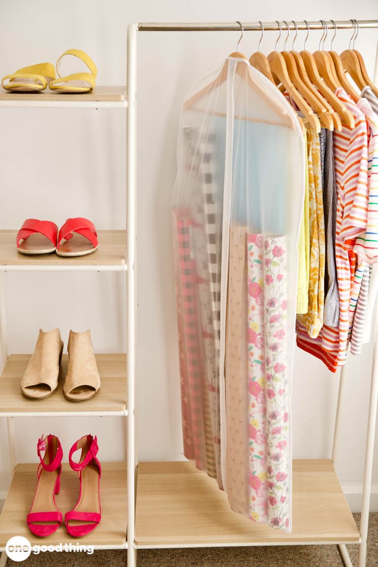 Holiday decor storage ideas featuring garment bag used as DIY gift wrapping paper bag