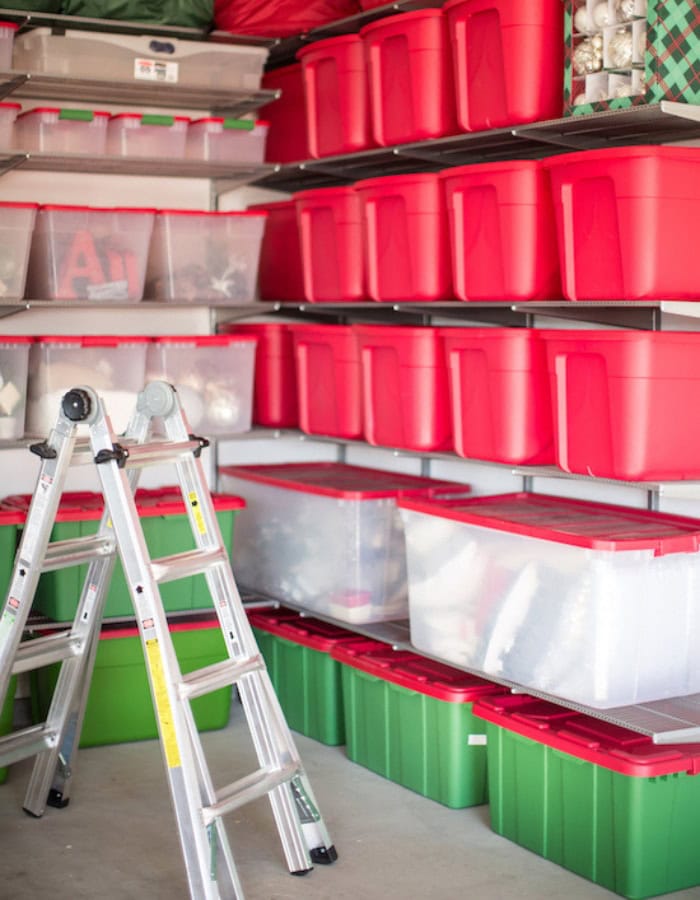 Holiday decor storage ideas featuring a shelving unit with white and red boxes