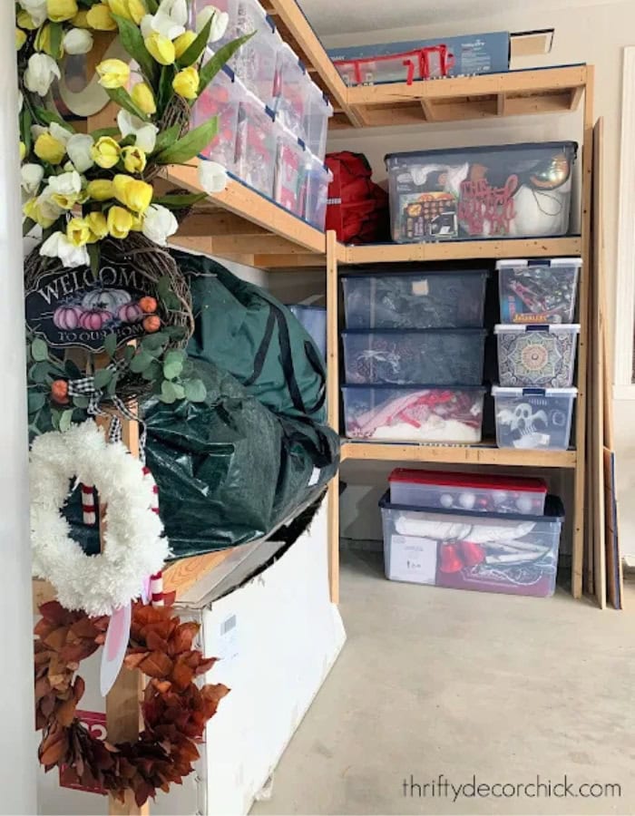 Holiday decor storage ideas featuring a shelving unit with white and red boxes