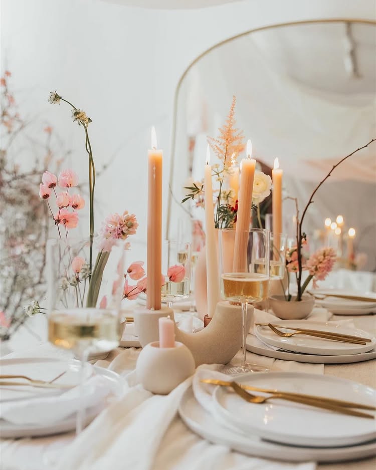 Valentines Day Brunch idea featuring a tablescape in pink and beige hues with long tapered candles