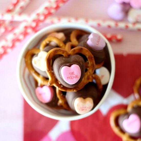 Example of Valentine’s Day kids dessert table featuring kid-friendly sweet treats in vibrant colors with on-themed decor around
