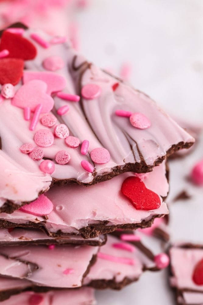 Example of Valentine's day kids dessert table featuring kid-friendly sweet treats in vibrant colors with on-themed decor around