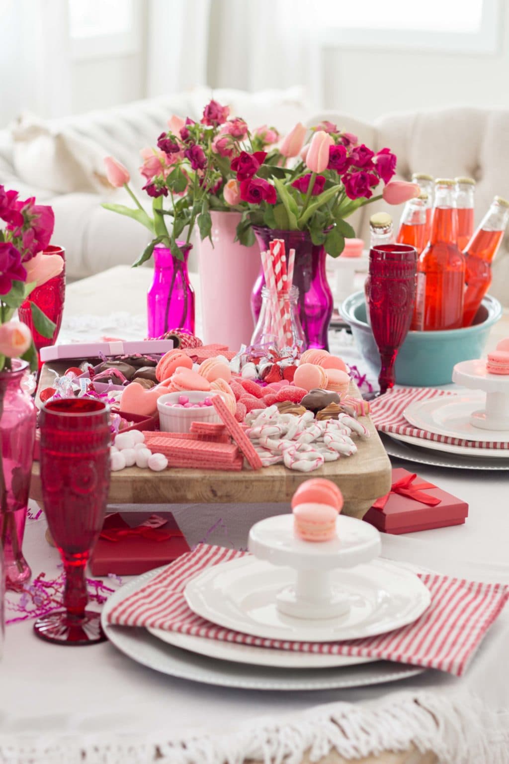 Example of Valentine’s Day kids dessert table featuring kid-friendly sweet treats in vibrant colors with on-themed decor around