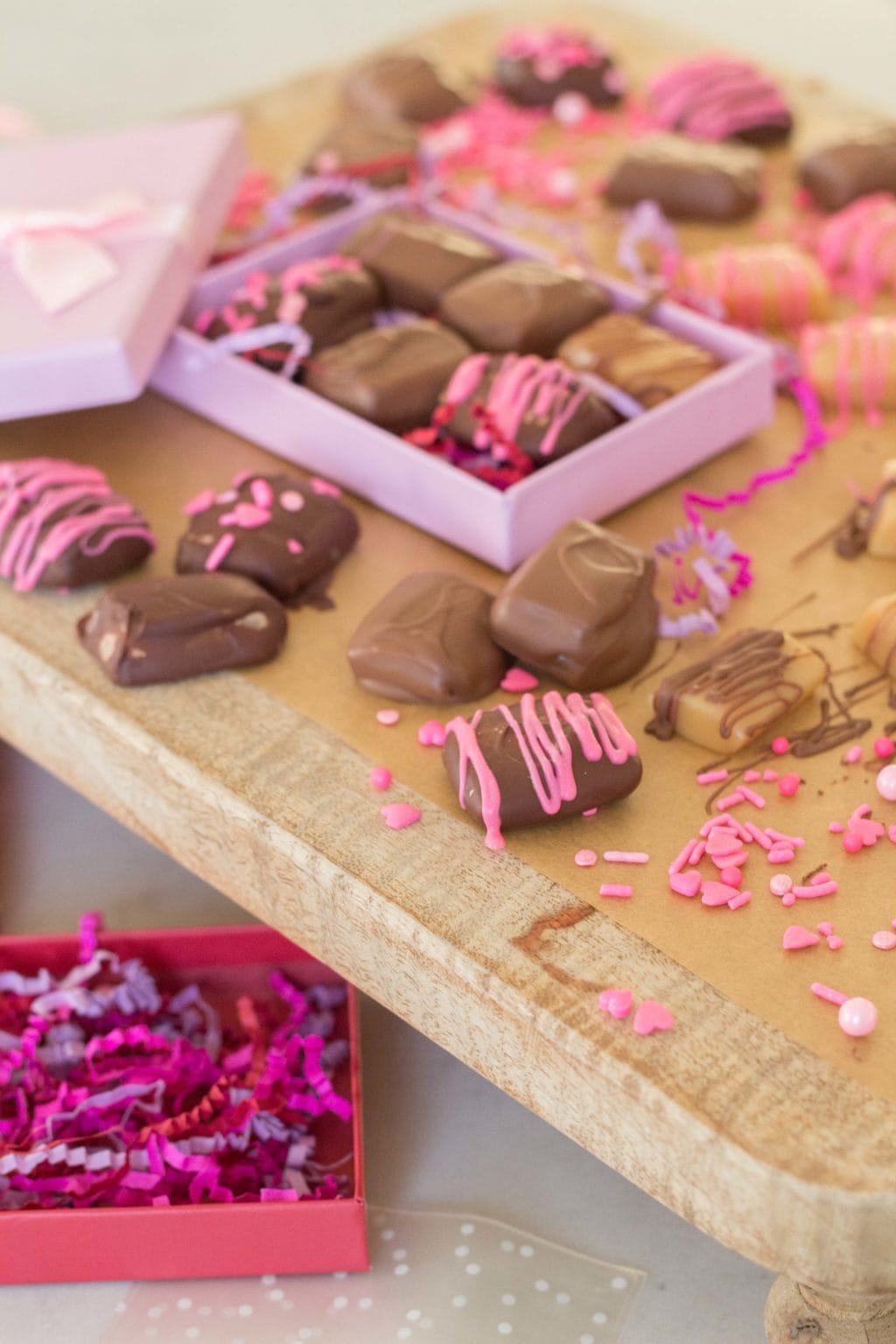Example of Valentine's day kids dessert table featuring kid-friendly sweet treats in vibrant colors with on-themed decor around