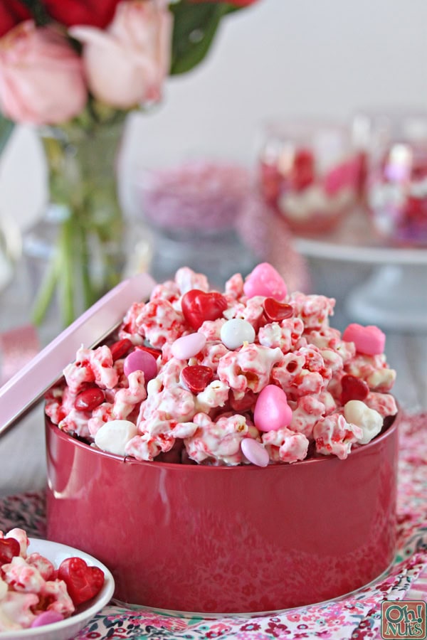 Example of Valentine's day kids dessert table featuring kid-friendly sweet treats in vibrant colors with on-themed decor around