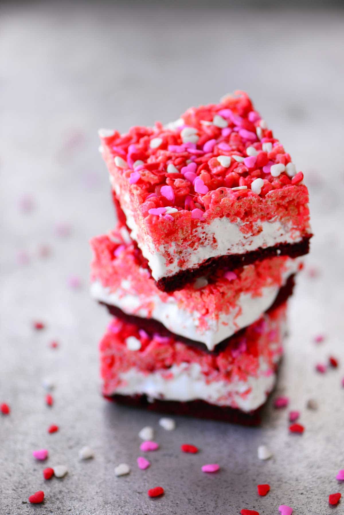 Example of Valentine's day kids dessert table featuring kid-friendly sweet treats in vibrant colors with on-themed decor around