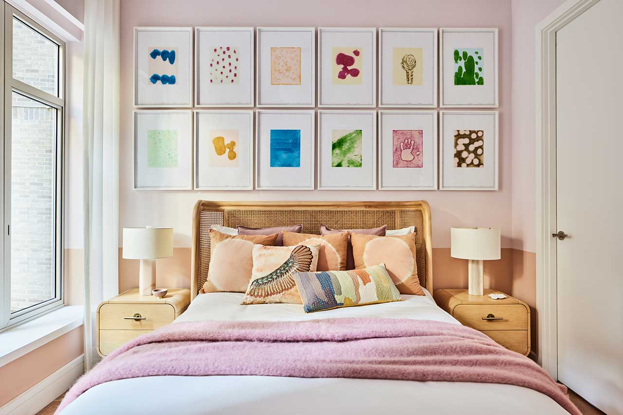 Home design trends 2025 idea featuring an eclectic bedroom with light pink and light brown hues and colorful gallery wall