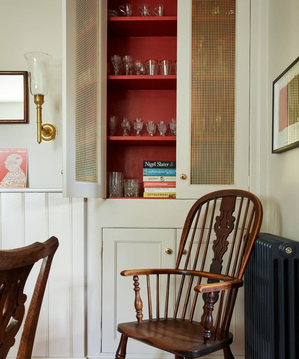 Home design trends 2025 idea featuring a small kitchen with an unexpected red theory hidden wall accent