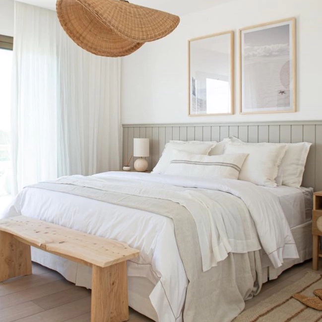 Home design trends 2025 idea featuring a bedroom with a sculpural organic lamp above the bed