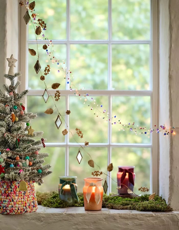 Kid-friendly Christmas party idea featuring a delicate garland decorating a window