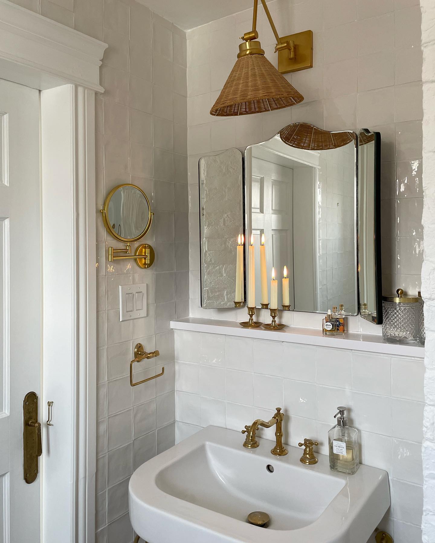 Example of how to use mirrors and lighting to enhance a space featuring a bathroom with a antique mirrors