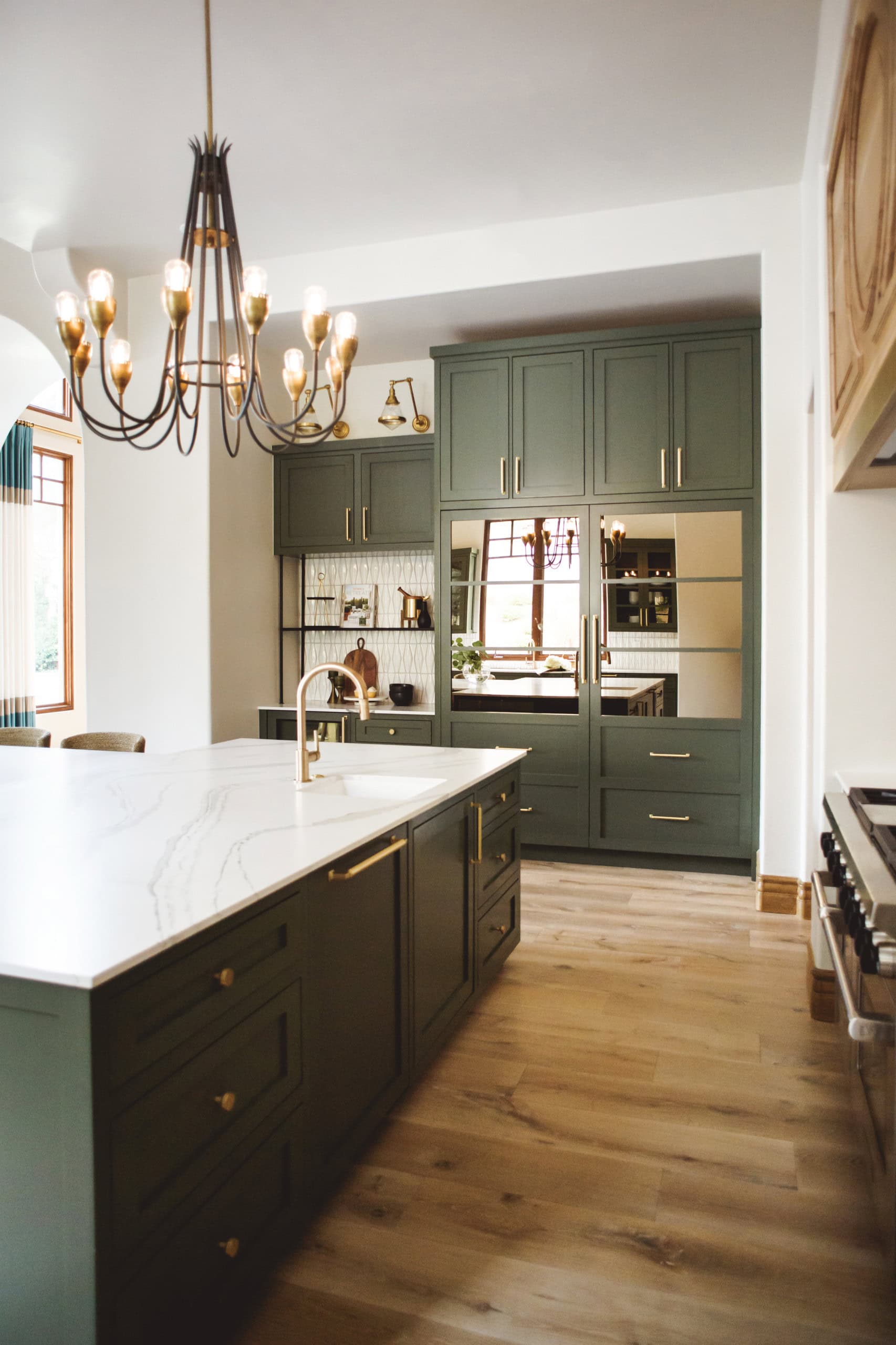 Example of how to use mirrors and lighting to enhance a space featuring amodern traditional kitchen