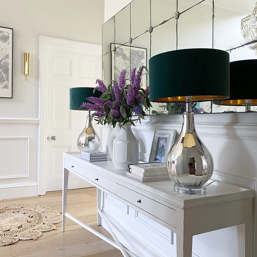 Example of how to use mirrors and lighting to enhance a space featuring a bedroom with large furniture