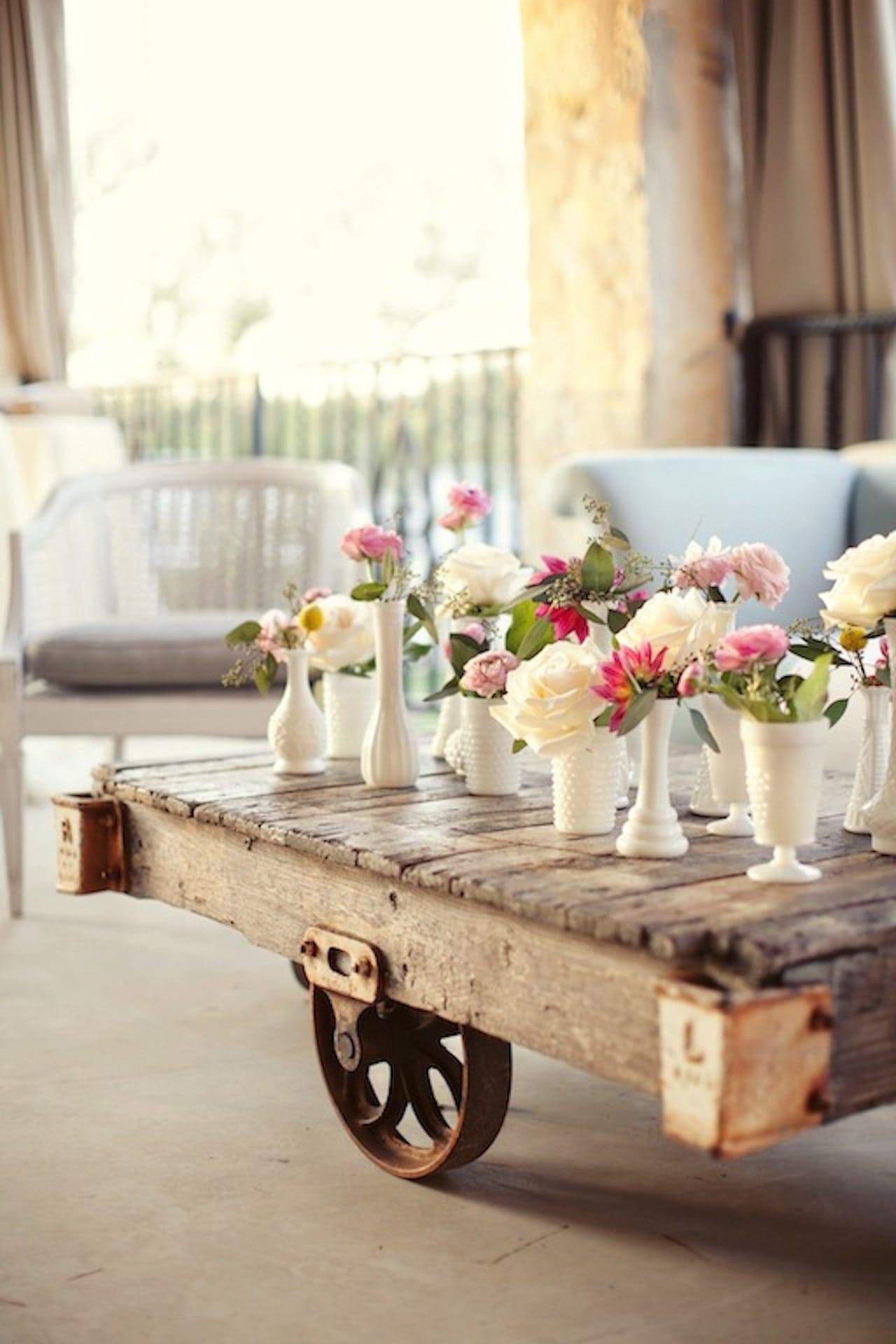Vintage Valentine's Day decor idea featuring milk vases with pink and white floral arrangements