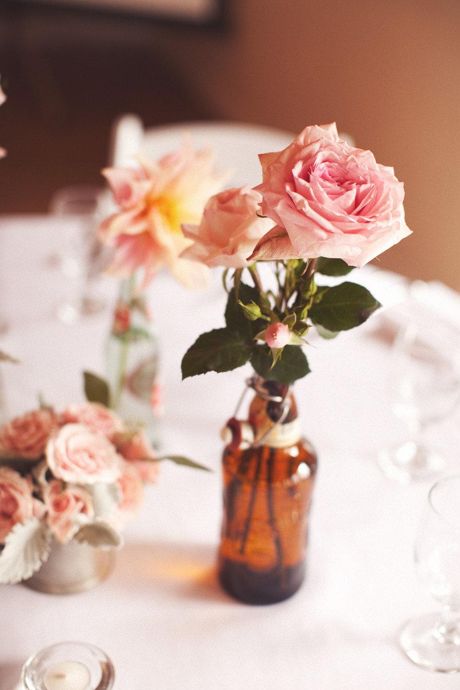 Vintage Valentine's Day decor idea featuring apothecary bottle with pink flower