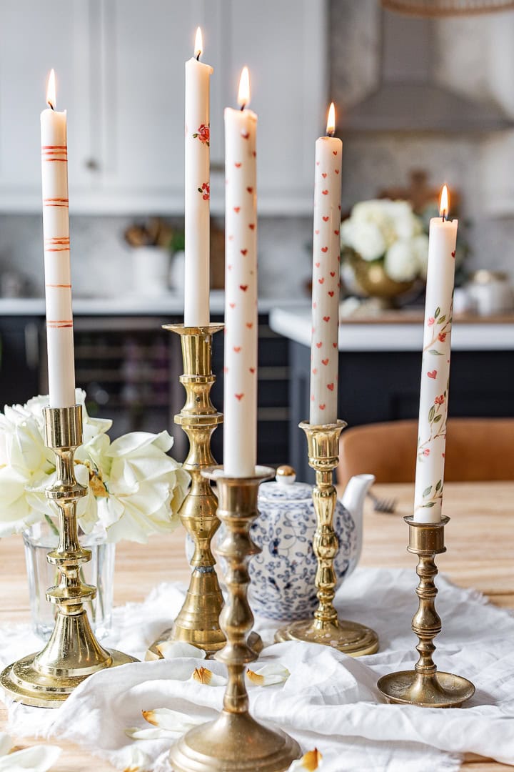 DIY Valentine's Day Decor idea featuring tall candles with hand-painted hearts