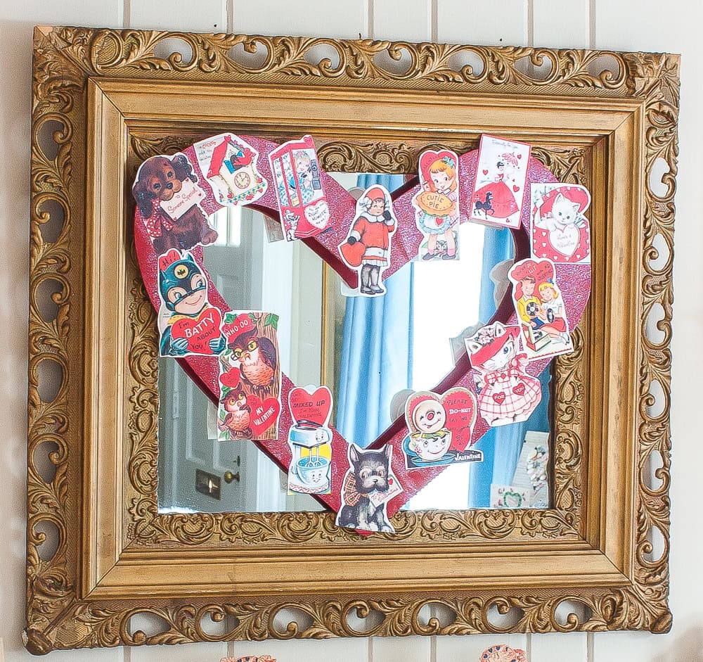 Vintage Valentine's Day decor idea featuring vintage valentine cards in heart-shaped on mirror